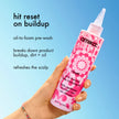 Pink charcoal scalp cleansing oil bottle with pump nozzle in hand