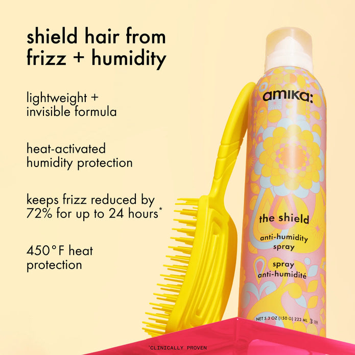 The Shield anti-humidity spray bottle next to comb, label text visible