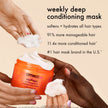 Amika Soulfood nourishing mask with cream in hands above orange jar