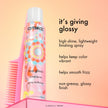 Hair gloss shine spray bottle with pink comb next to it and floral label