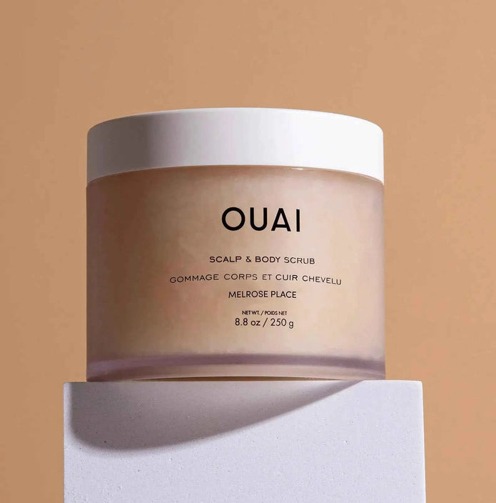 Ouai scalp and body scrub jar with white label on cream container