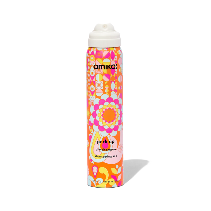 Dry shampoo bottle with colorful pattern and white spray cap, angled view