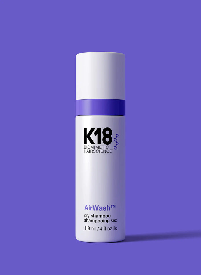 K18 AirWash dry shampoo bottle with purple cap and white label, 118 ml
