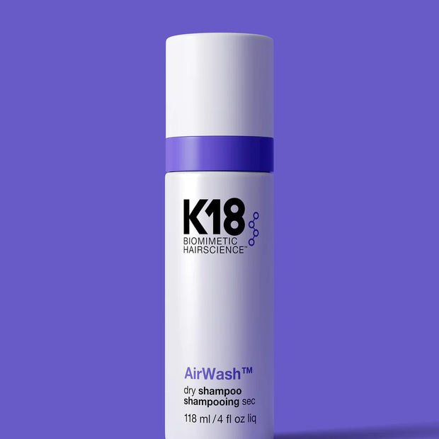 K18 AirWash dry shampoo bottle with purple cap and white label, 118 ml