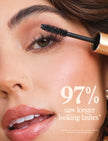 Black mascara brush applicator applying on eye lashes, close-up for fuller look