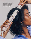 Satin Blush curling straightener styling hair with clamp plates, held in hand