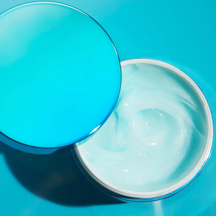 Jar with lid open, showing creamy blue conditioner inside for Money Masque