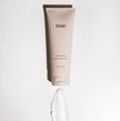 OUAI Curl Crème squeeze tube with flip-top cap, light beige