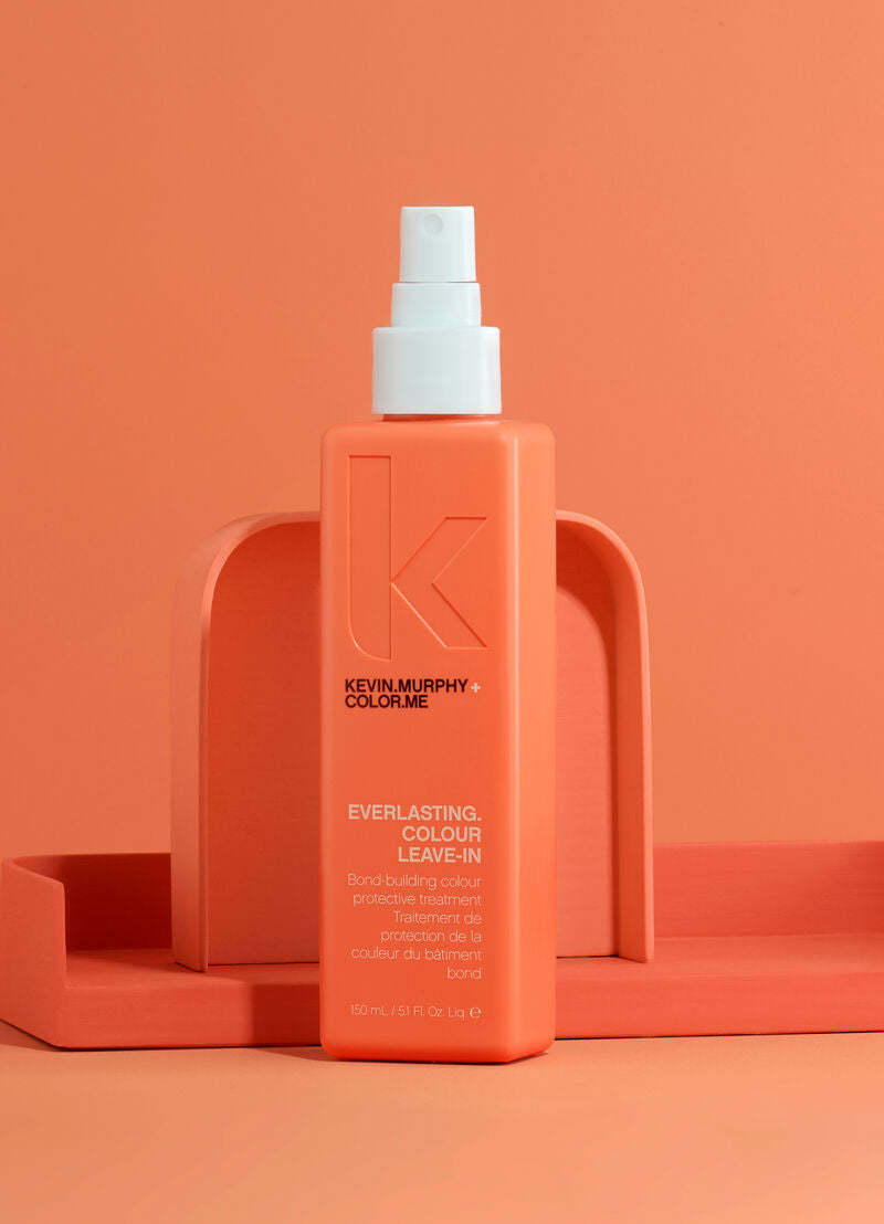 Coral-orange leave-in color treatment bottle, front label and spray pump