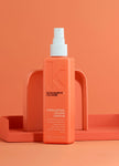 Coral-orange leave-in color treatment bottle, front label and spray pump