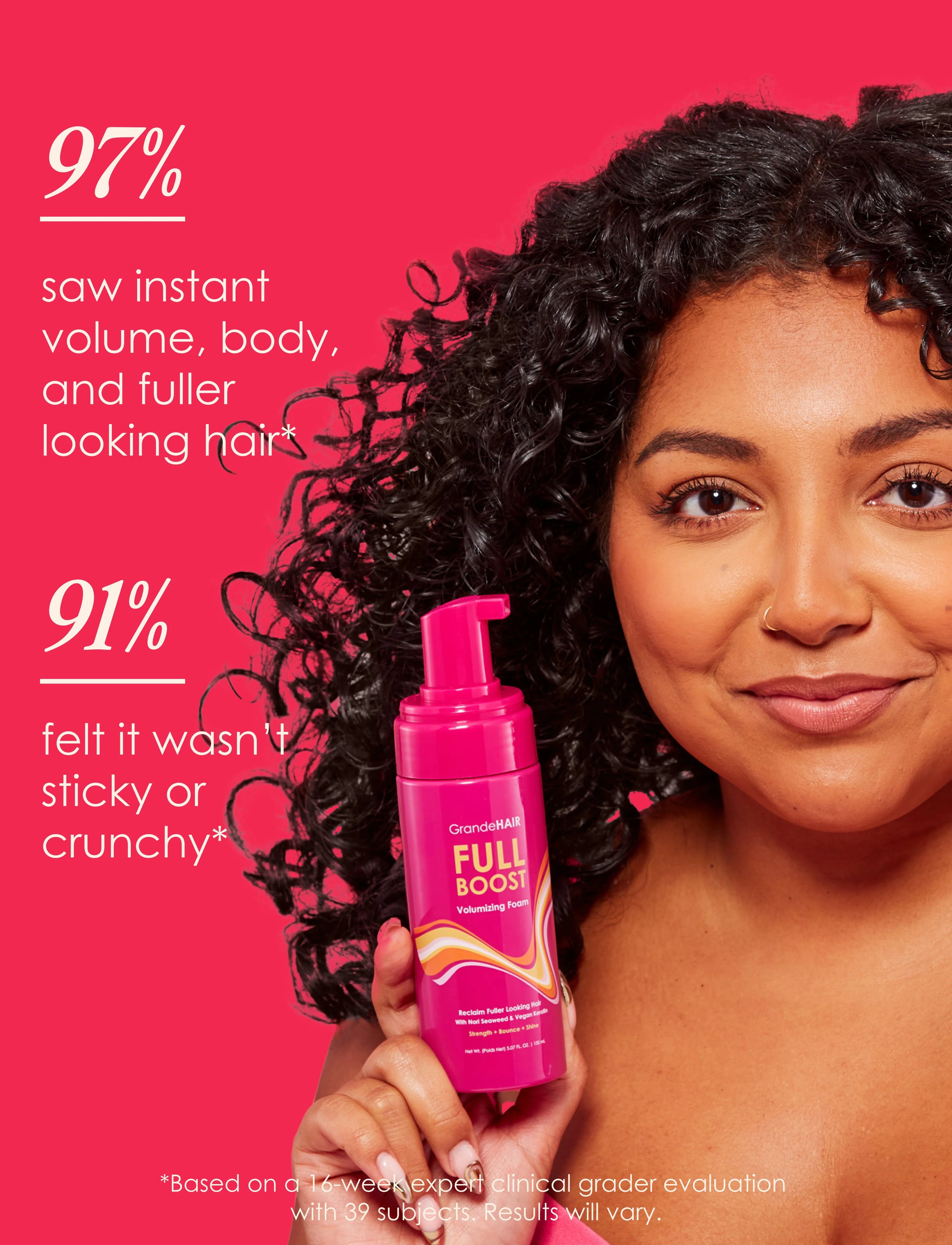 Woman holding GrandeHAIR Full Boost volumizing foam bottle with pink pump