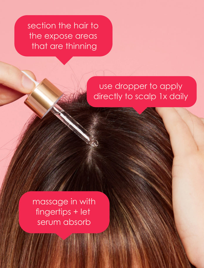 Hair serum dropper applying clear drops to scalp after parting hair