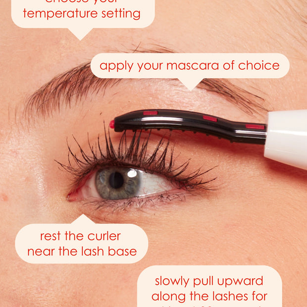 Heated lash curler warming lashes near the lash line on an eye