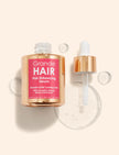 Hair Enhancing Serum set: clear bottle and gold dropper bottle with labels visible