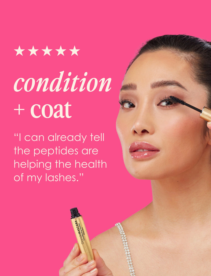Woman applying dark mascara with golden tube; visible lifted lashes