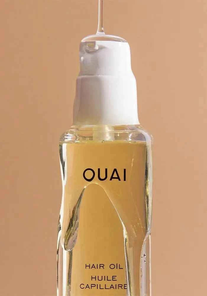 Ouai hair oil bottle close-up with amber liquid and front label