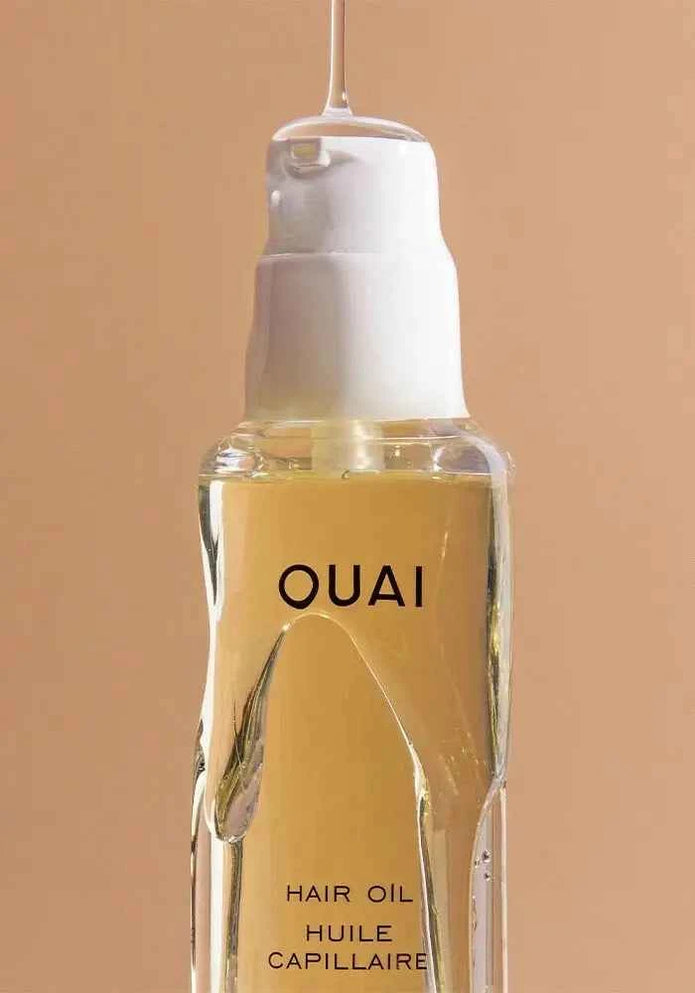 Ouai hair oil bottle close-up with amber liquid and front label
