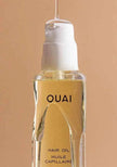 Ouai hair oil bottle close-up with amber liquid and front label