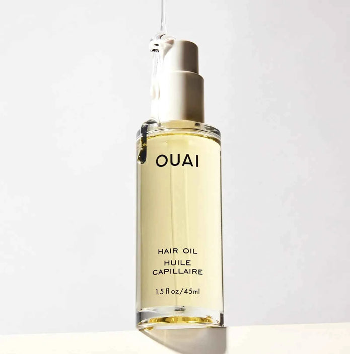 Ouai hair oil bottle with pump, amber liquid, label on front