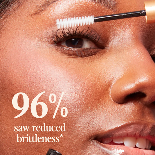 Mascara-style lash conditioner brush with white gel on upper lashes