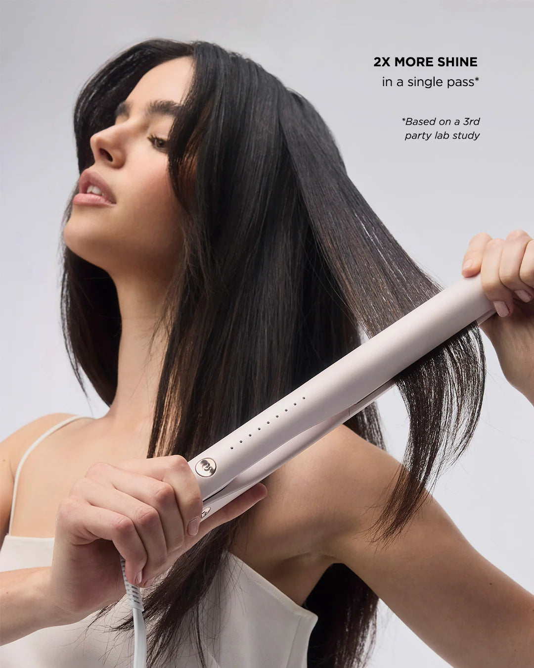Hair straightener used on long black hair, glossy straightened strands