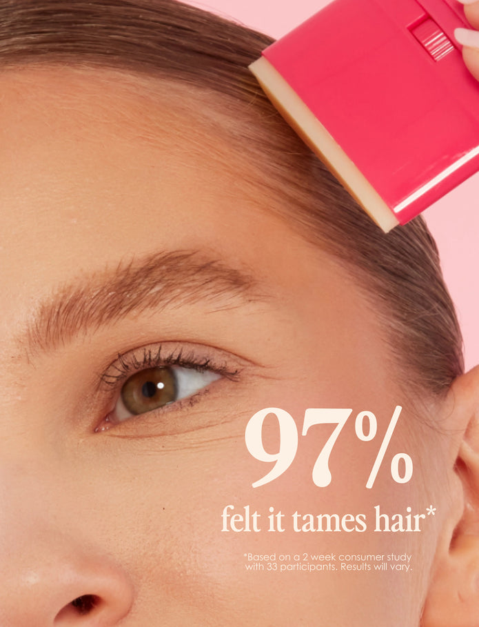 Pink Slick Back taming stick held near hairline for slick, styled look
