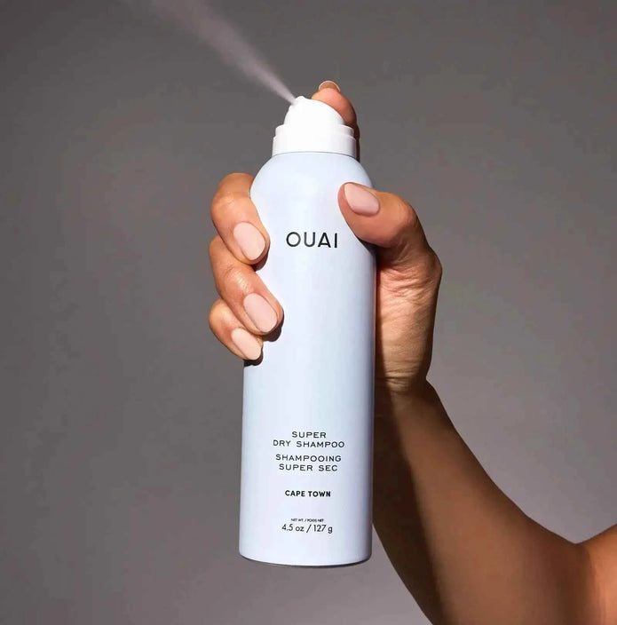 Dry shampoo bottle, white bottle with OUAI logo and spray nozzle