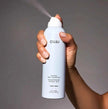 Dry shampoo bottle, white bottle with OUAI logo and spray nozzle