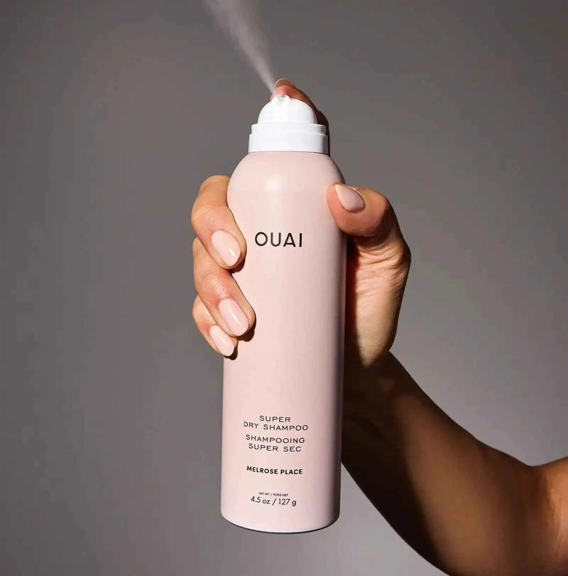 Ouai Super Dry Shampoo bottle, pale pink with white cap and nozzle