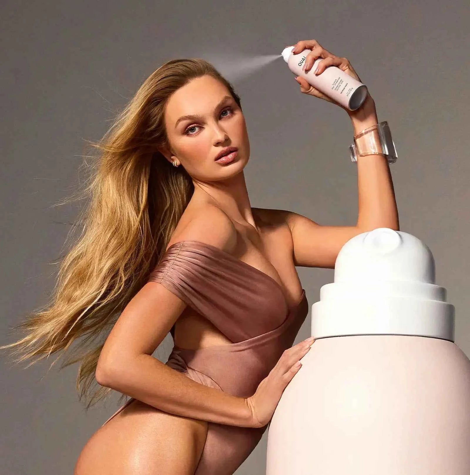 Ouai Super Dry Shampoo bottle with OUAI label, pale pink and white cap