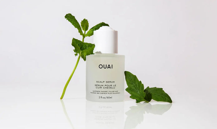 OUAI scalp serum bottle with white cap on clean surface