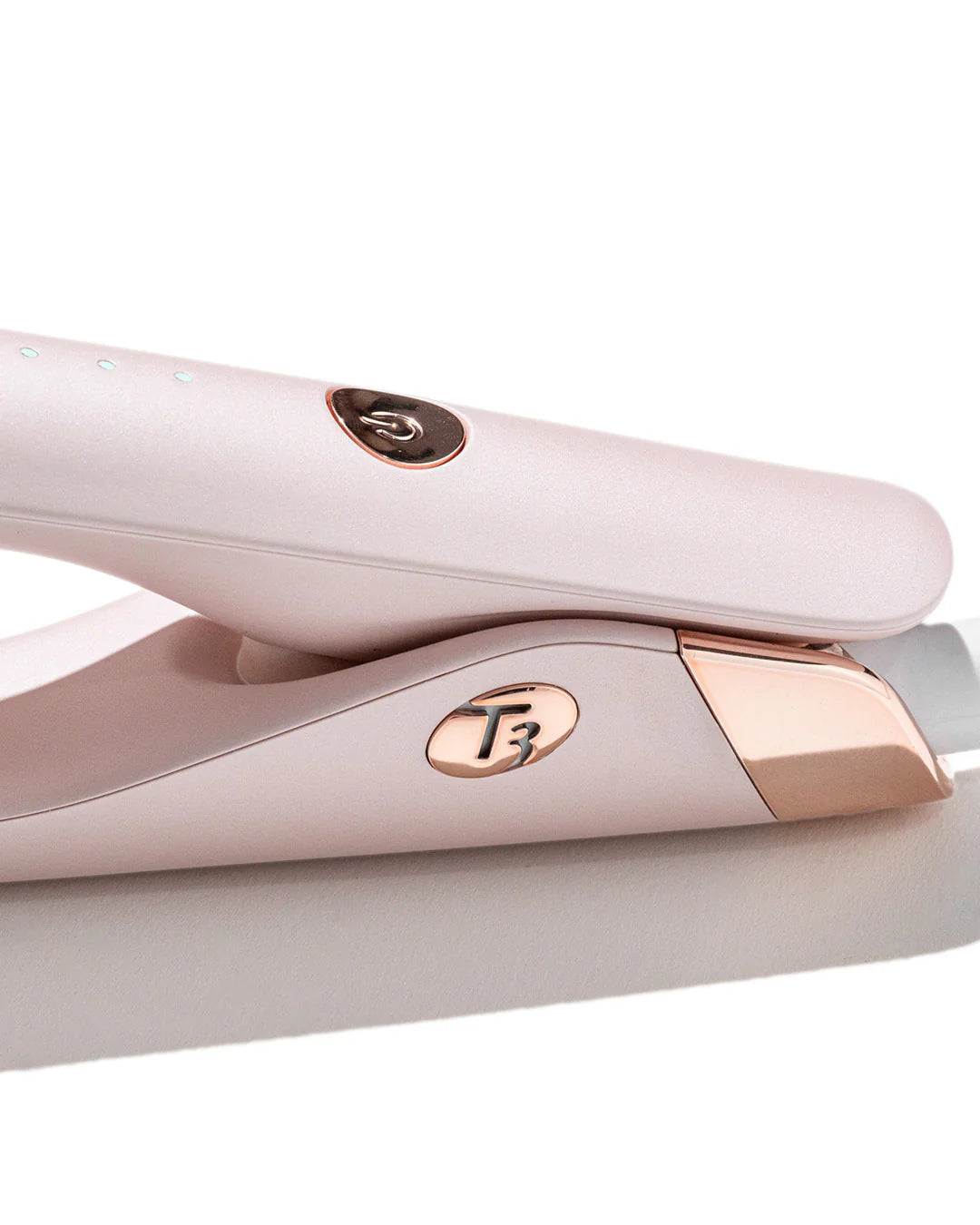 Close-up of light pink T3 SinglePass straightener handle and control area