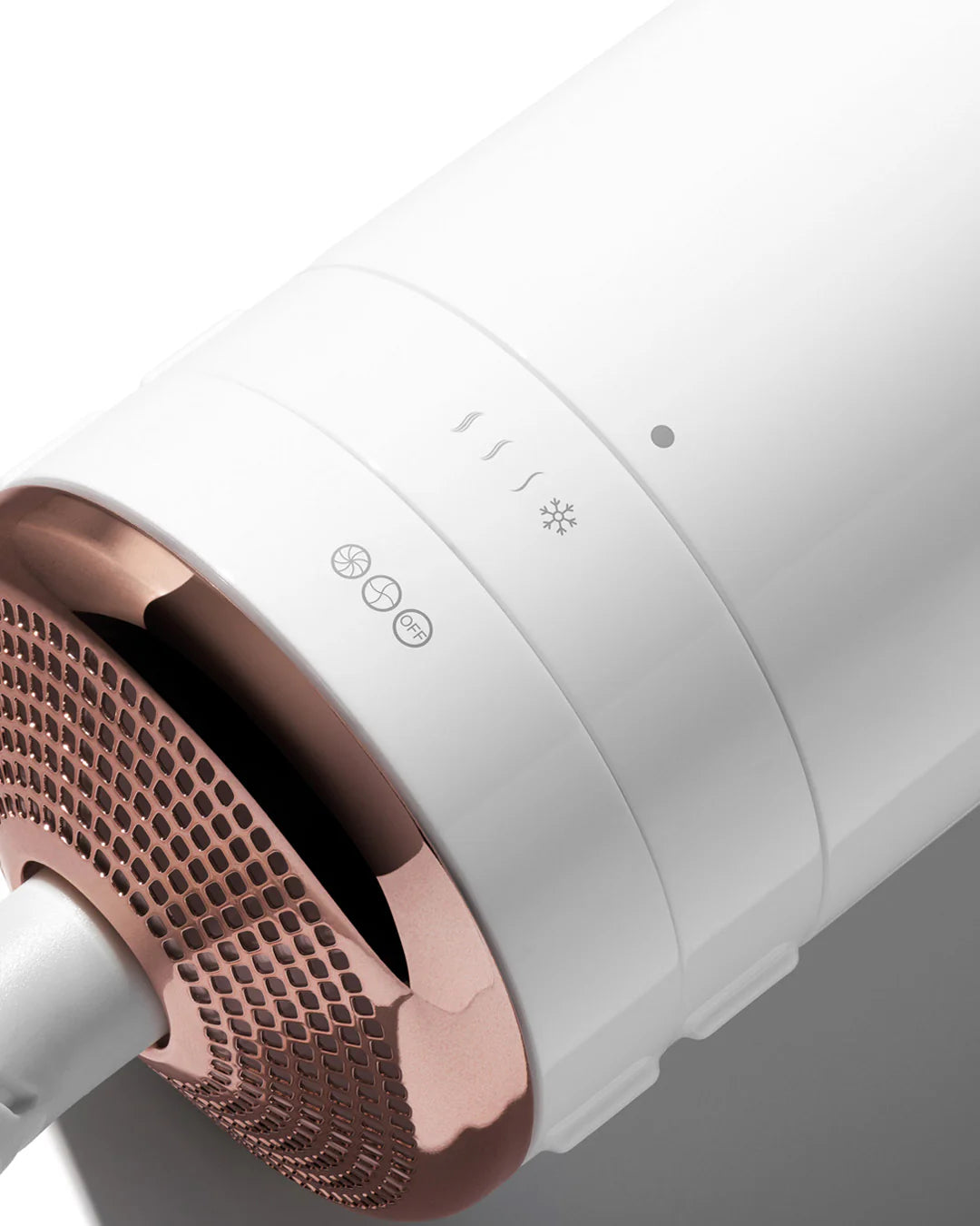 White hair styler close-up of side controls and air vent grille on the barrel