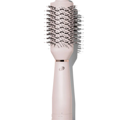 Satin blush heated brush styler with dense black bristles on a pink handle base