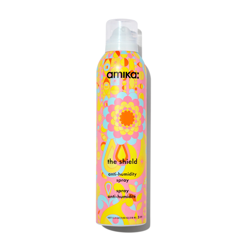 The Shield anti-humidity spray bottle with pastel floral pattern and white pump cap