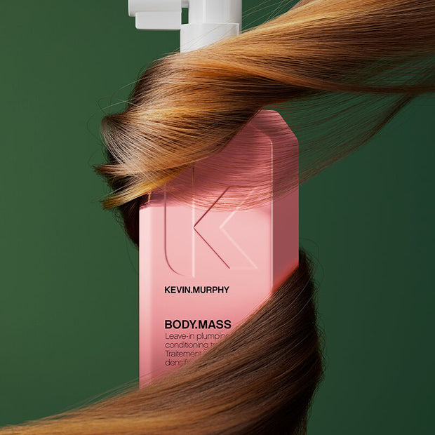 KEVIN.MURPHY BODY.MASS leave-in conditioning treatment; pink bottle over flowing hair