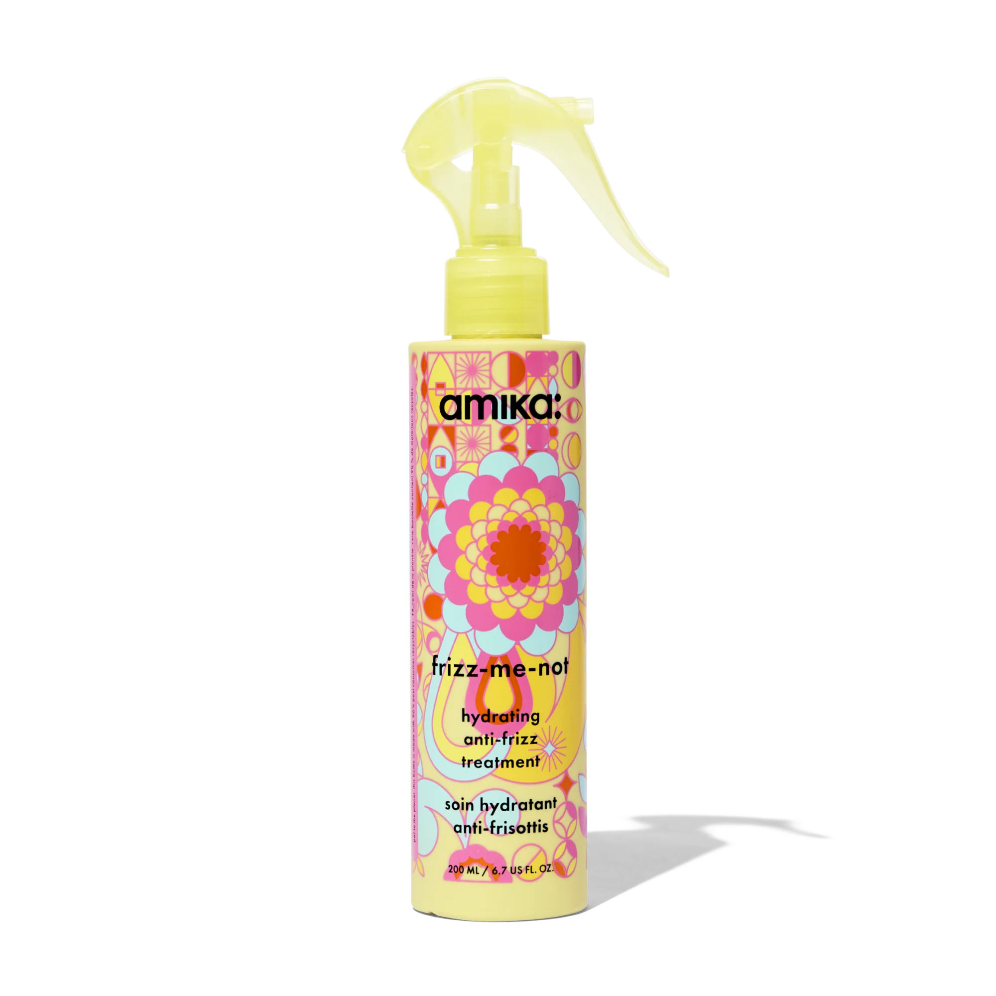 Yellow anti-frizz hair treatment bottle with pump sprayer, colorful label