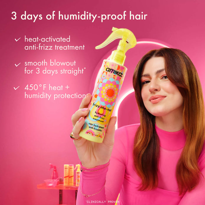Hand holding yellow anti-frizz treatment spray bottle above smooth, glossy hair